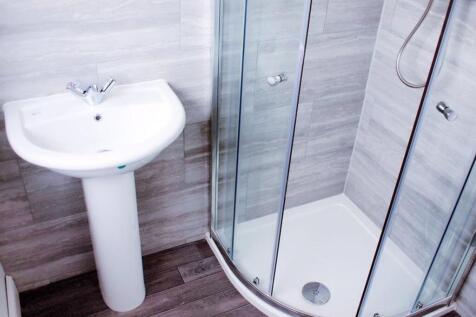 Modern bathroom featuring a sleek shower enclos...