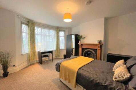 This spacious double bedroom features large win...