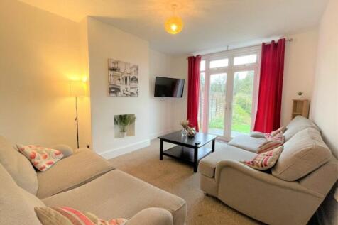 Bright and inviting living room featuring comfo...