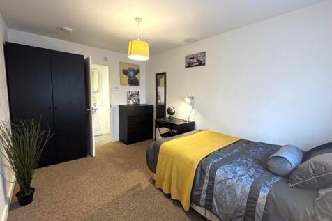This inviting double bedroom features a cozy at...