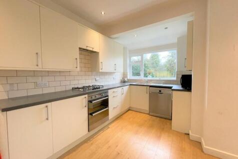 This modern kitchen features sleek cabinetry, a...
