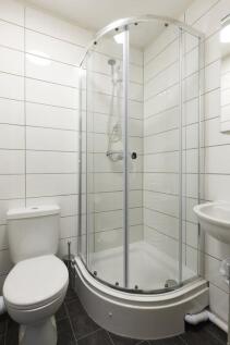 Modern bathroom featuring a sleek shower enclos...