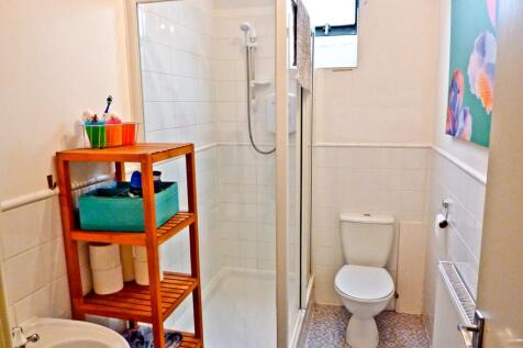 A modern bathroom featuring a spacious shower, ...
