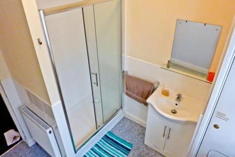 A tidy bathroom featuring a modern shower and b...