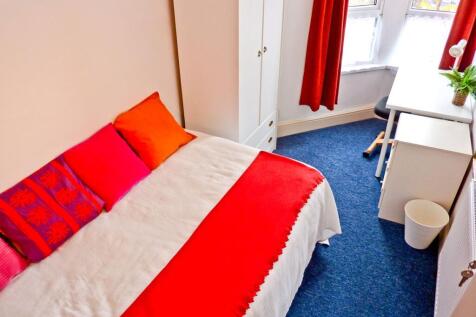 A vibrant and cozy double bedroom featuring a c...