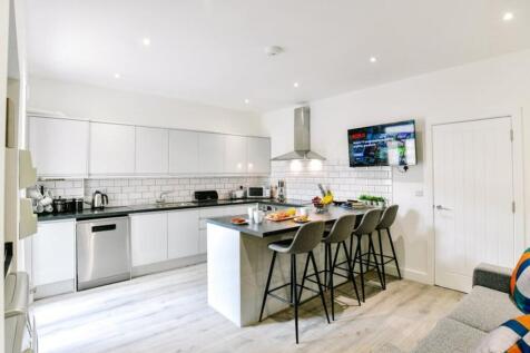 This modern kitchen boasts a sleek design with ...