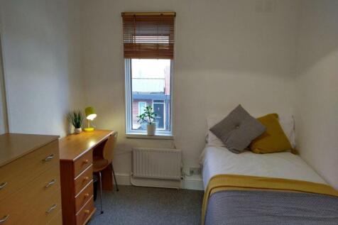 This cozy double bedroom features a comfortable...