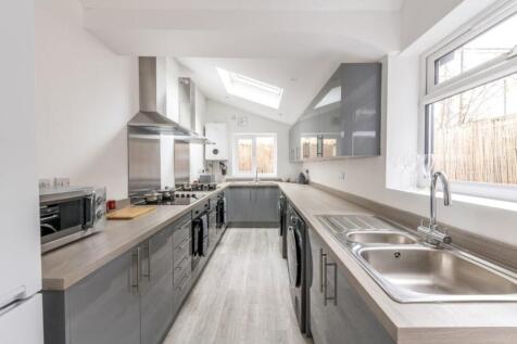 A modern kitchen featuring sleek cabinetry and ...