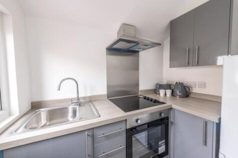 Modern kitchen featuring sleek cabinetry, a spa...