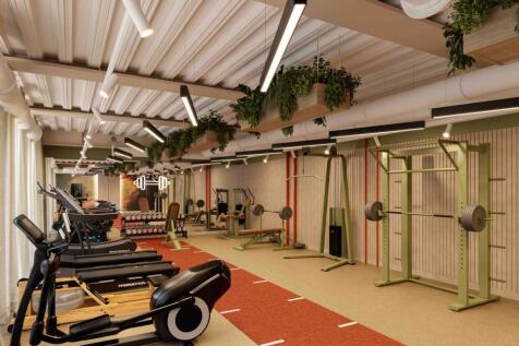 A spacious and well-equipped gym featuring mode...