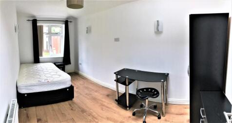 Spacious double bedroom featuring a large windo...