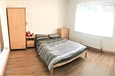 Bright and spacious double bedroom featuring a ...