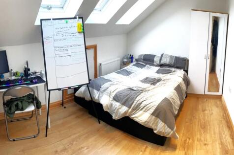 Bright and spacious double bedroom featuring a ...