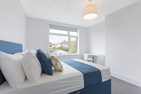 Bright and spacious double bedroom featuring a ...