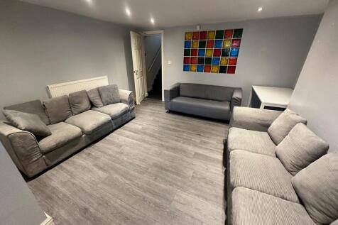 Spacious and inviting living room featuring com...