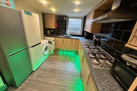 This modern kitchen features sleek cabinetry, a...