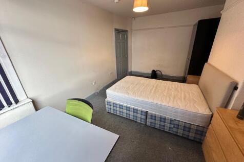 Spacious double bedroom featuring a comfortable...