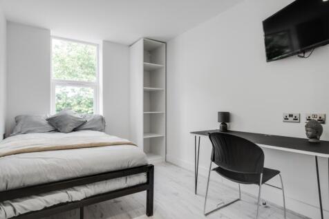 A bright and inviting double bedroom featuring ...