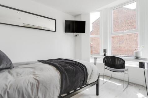 A bright and inviting double bedroom with moder...