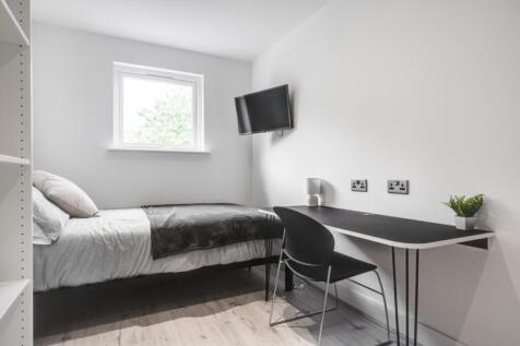 A bright and tidy double bedroom featuring a co...