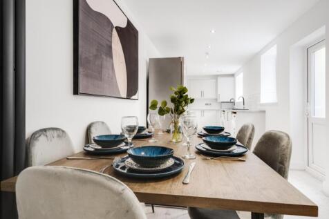 A stylish kitchen area with a modern dining set...