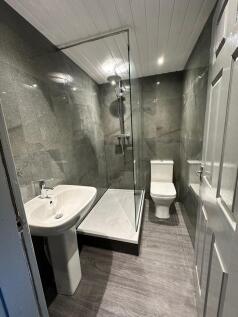 A sleek and modern bathroom featuring a spaciou...