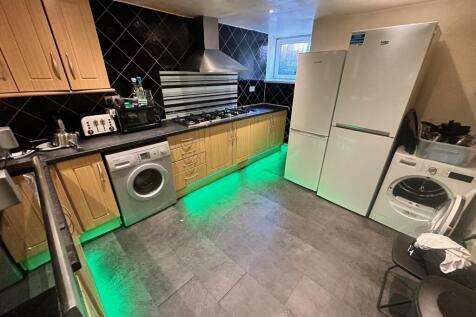 Modern kitchen featuring sleek cabinetry, ample...