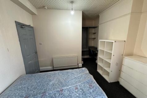 Spacious double bedroom featuring ample natural...