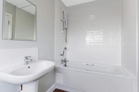 A modern bathroom featuring a sleek bathtub and...