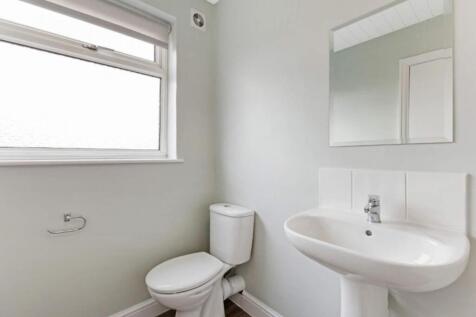 A bright and modern bathroom featuring a sleek ...