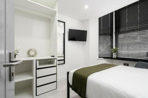 A modern and stylish double bedroom featuring a...