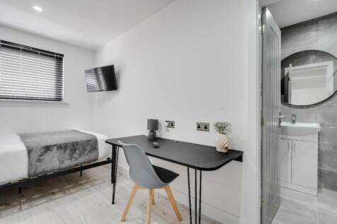 A stylish and modern double bedroom featuring a...