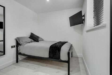 A modern and tidy double bedroom featuring a st...