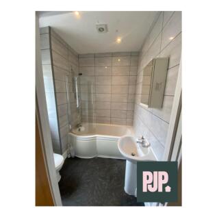 A beautifully designed bathroom featuring a spa...