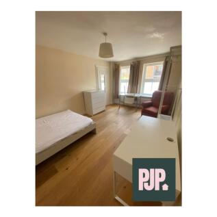 A bright and spacious double bedroom featuring ...