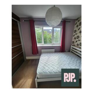 This inviting double bedroom features a bright ...
