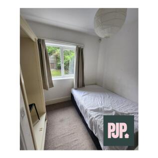 Cozy double bedroom featuring a comfortable bed...
