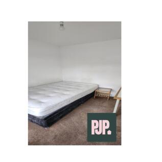 Spacious double bedroom featuring a comfortable...