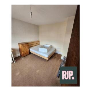 A spacious double bedroom featuring ample natur...