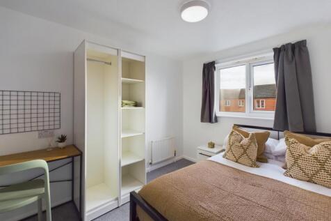 A bright and inviting double bedroom featuring ...