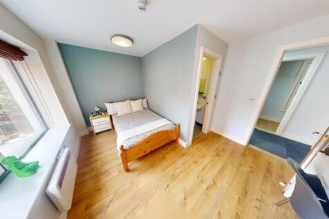 A spacious and inviting double bedroom with amp...