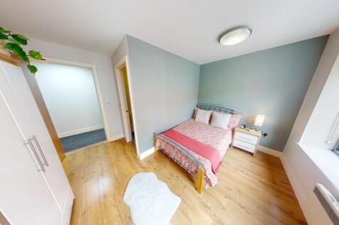 A bright and inviting double bedroom with moder...