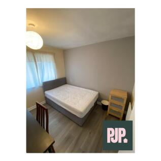 Bright and spacious double bedroom featuring am...