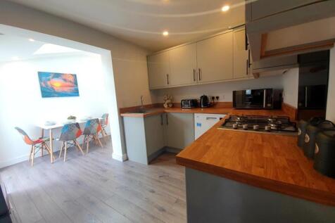 Modern kitchen featuring sleek cabinetry and a ...