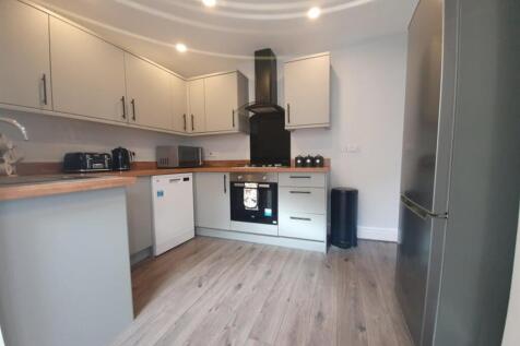 Modern kitchen featuring ample cabinetry and co...