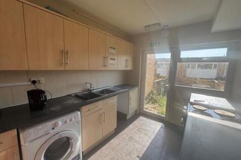 Bright and modern kitchen featuring ample cabin...