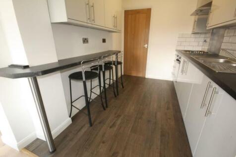 Modern kitchen featuring sleek cabinetry, ample...