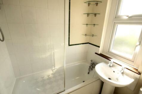 A well-maintained bathroom featuring a shower o...
