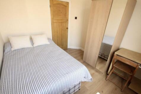 Cozy double bedroom featuring a comfortable bed...