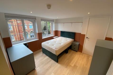 Spacious double bedroom featuring large windows...